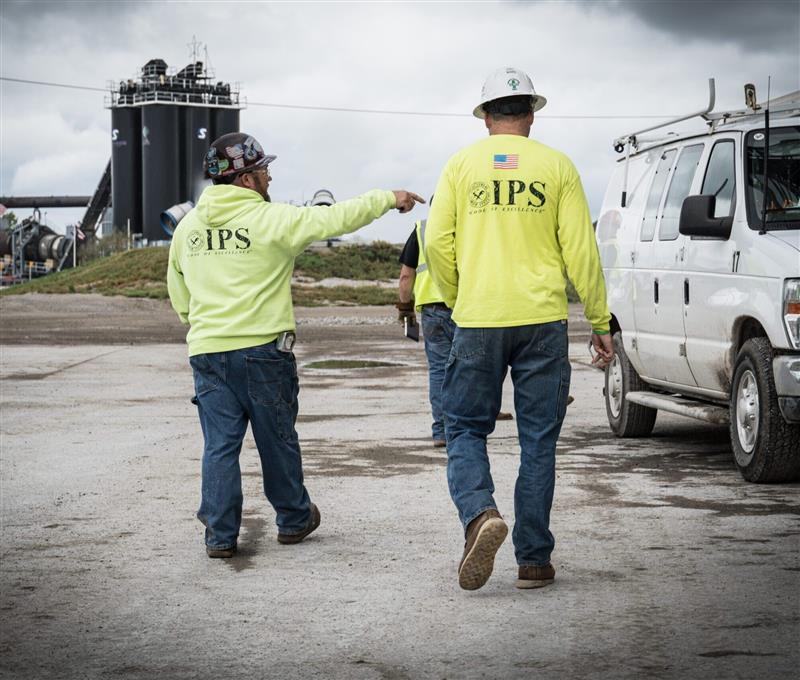 two construction men walking to the job site in IPS apparel